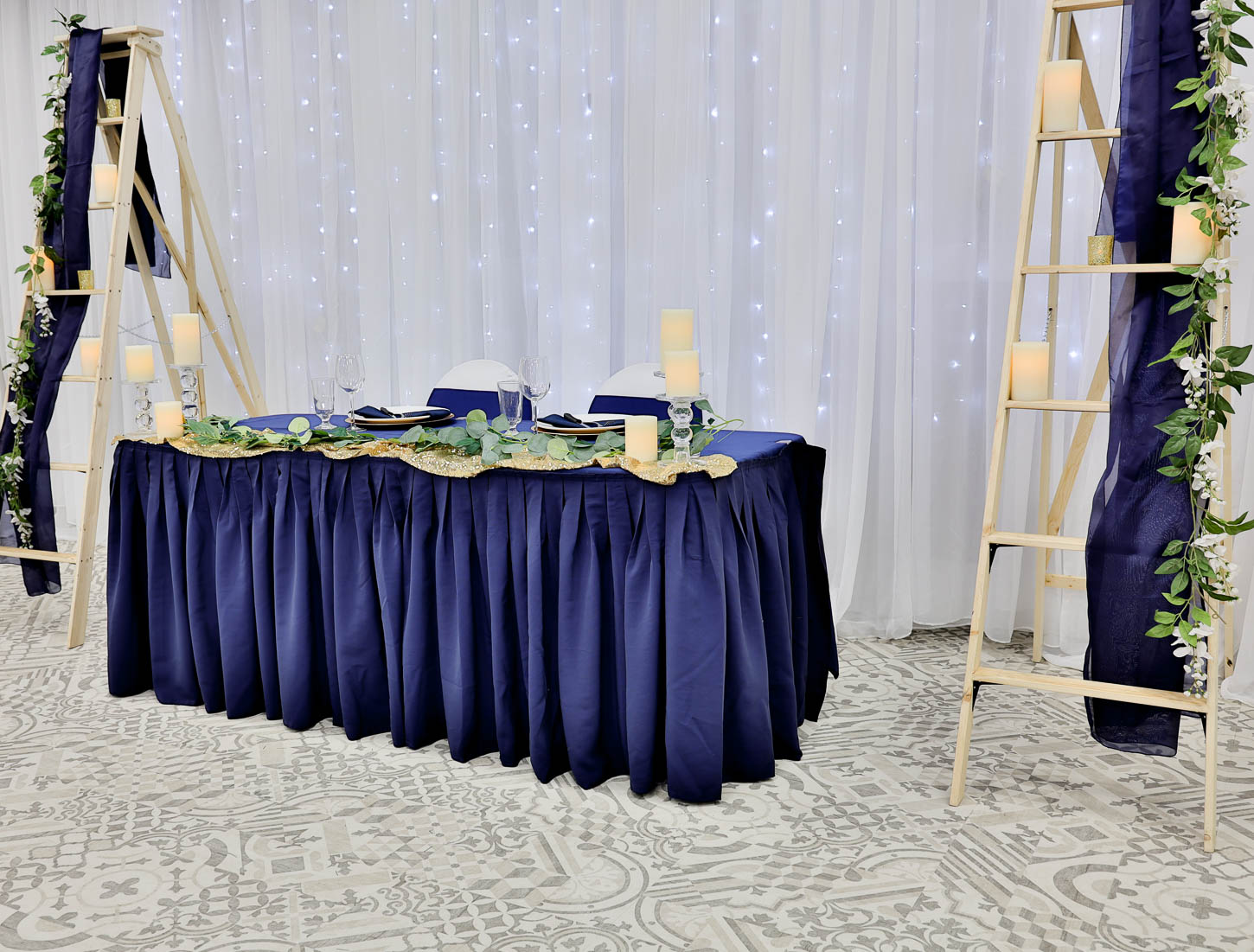 Ceremony arch with chairs and draping lights